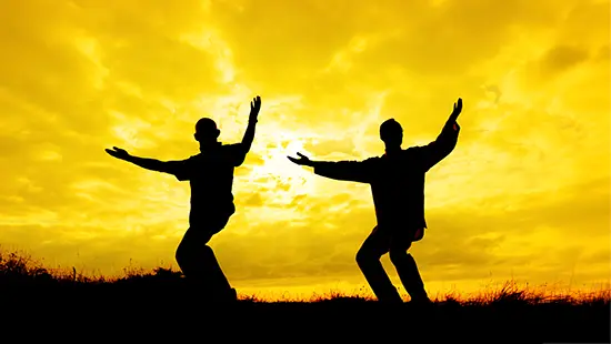 Tai Chi classes background, abstract image with two students with bright yellow sunrise